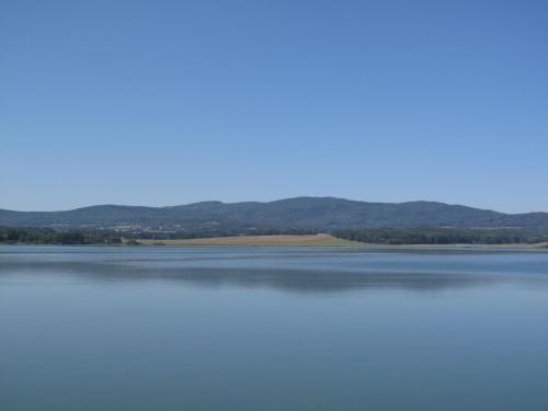 a view of the water with mountains in the background at Chalet Panorama by Interhome in Dehtáře