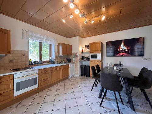 a kitchen with a table and a dining room at Holiday Home LuxuSölk-3 by Interhome in Stein an der Enns