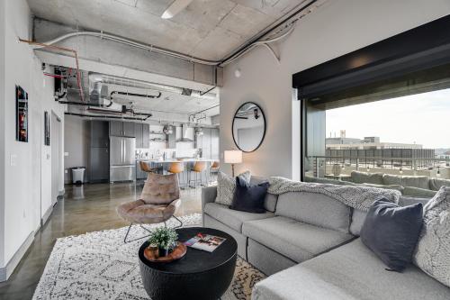 a living room with a couch and a table at Sable 71 - loft in Minneapolis