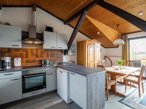 a kitchen and dining room with a table at Apartment Nordsee-Ferienhaus-3 by Interhome in Friedrichskoog