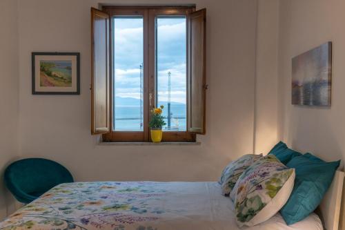 a bedroom with a bed and a window with a view at Mamma Rosa Be Home in Salerno