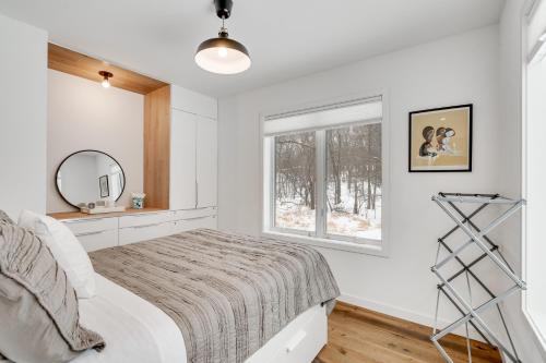 - une chambre blanche avec un lit et une fenêtre dans l'établissement Modern Chic, à Lake Elmo