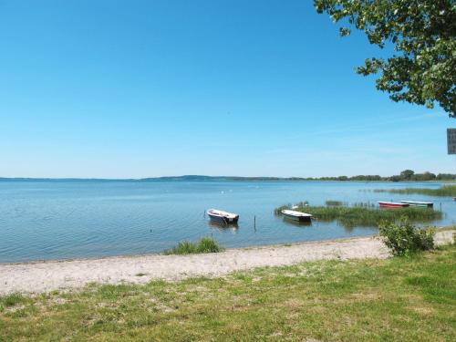 two boats sitting in the water next to a beach at Holiday Home Ferienpark Verchen-2 by Interhome in Verchen