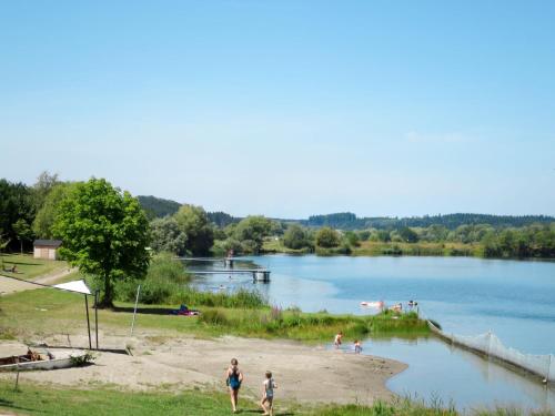a group of people on a beach near a lake at Apartment Land in Sicht by Interhome in Rulfingen