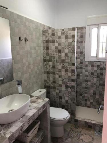 a bathroom with a sink and a toilet at Apartamentos Cala Isabel in Zahora