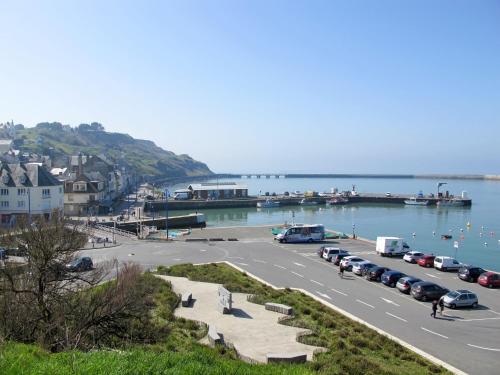 a parking lot with cars parked next to the water at Holiday Home Le Clos Renard by Interhome in Commes