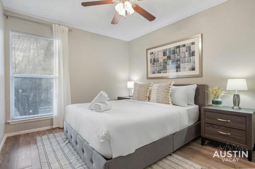 a bedroom with a large bed and a ceiling fan at Everything You Need Near S Lamar Perfect Condo in Austin