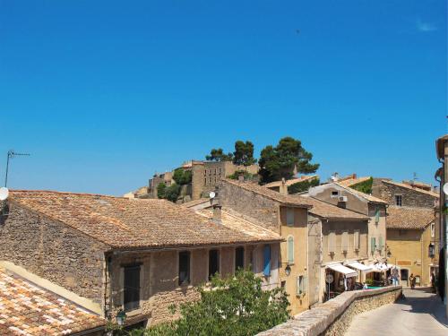 a view of a village with a hill in the background at Holiday Home L'Olivier by Interhome in Ménerbes