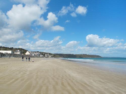 a group of people walking on a beach at Holiday Home Ty Manolo by Interhome in Tregueux