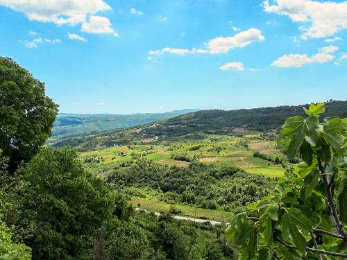 a view of a valley from a hill with trees at Holiday Home Kate by Interhome in Potpićan