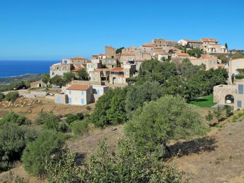 a village on top of a hill with the ocean at Holiday Home San Antoine by Interhome in LʼÎle-Rousse