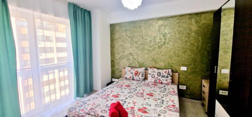 een slaapkamer met een bed met een bloemenbed bij Big & Cosy Apartment with 3 double beds by Evelyn Apartments in Iaşi