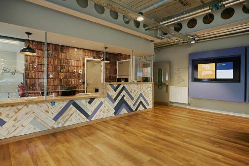 a large room with a counter and a projection screen at For Students Only Combworks at Aberdeen in Aberdeen
