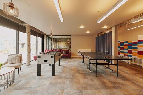 a living room with two ping pong tables in it at For Students Only Combworks at Aberdeen in Aberdeen