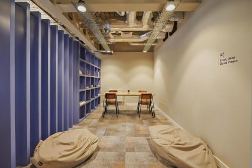 a room with a table and chairs and blue curtains at For Students Only Combworks at Aberdeen in Aberdeen