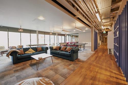 a living room with two couches and a table at For Students Only Combworks at Aberdeen in Aberdeen