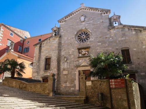 an old stone building with a tree in front of it at Holiday Home Noel by Interhome in Raša
