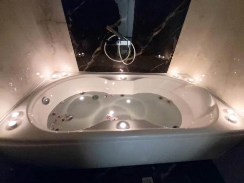 a white bath tub with lights in a bathroom at SITIA CITY CENTER luxury apartment in Sitia