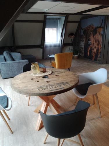 a living room with a wooden table and chairs at Vakantieverhuur Noordwolde in Noordwolde