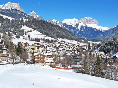 a town in the snow with mountains in the background at Apartment Carmen-3 by Interhome in Soraga