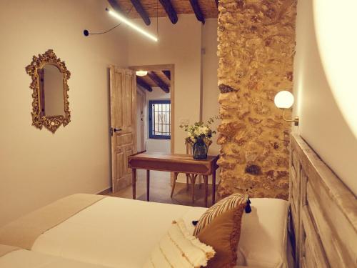 a bedroom with a bed and a table in a room at LIGNUM Casa Rural in Ayna