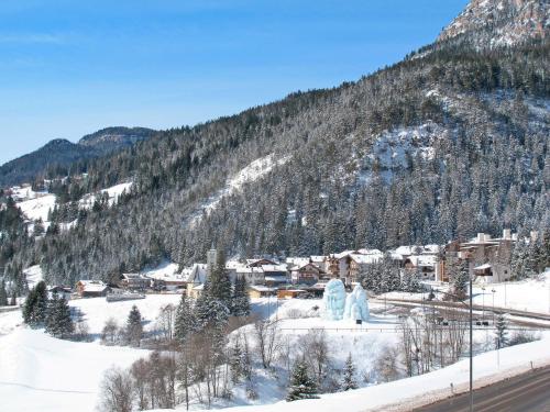 a town in the snow with a mountain at Apartment Cecilia-4 by Interhome in Campitello