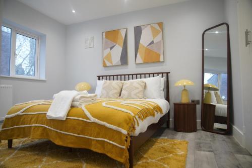 a bedroom with a bed and a large mirror at Lux 3BDR for 7 nr London Eye in London