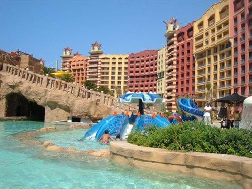 a group of people laying in the water at a water park at Porto marina chalet and apartment in El Alamein