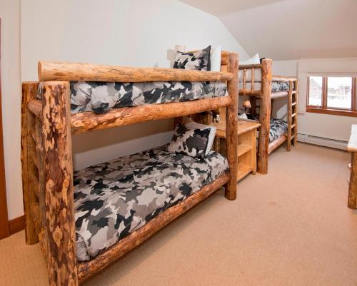 a bedroom with three bunk beds in a room at Snowcloud 302SC in Avon