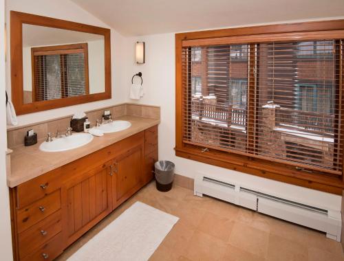 a bathroom with two sinks and a large window at Snowcloud 302SC in Avon
