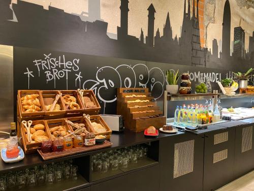 a bakery with bread and pastries on a counter at Catalonia Berlin Mitte in Berlin