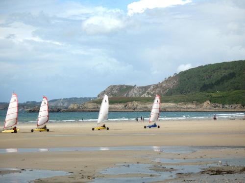 a group of small sailboats on a beach at Holiday Home Orphée by Interhome in Telgruc-sur-Mer