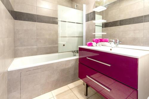 a bathroom with a purple vanity and a bath tub at Appartement de 2 chambres avec wifi a Saint Sorlin d'Arves in Saint-Sorlin-dʼArves