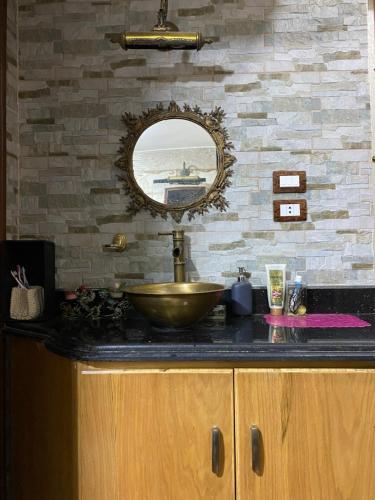 a bathroom counter with a sink and a mirror at Comfy private room with big sunny balcony near cairo airport مكان مودرن للاقامة دقائق من مطار القاهرة الدولى in Cairo