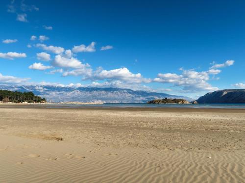 a view of a beach with mountains in the background at Villa Pinnidae by Interhome in Lopar