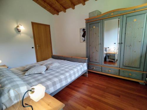 a bedroom with a bed and a cabinet and a table at Holiday Home Villa Massimo by Interhome in Carlazzo