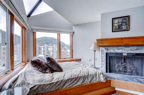 a bedroom with a bed and a fireplace at Lakeside 1491 in Keystone