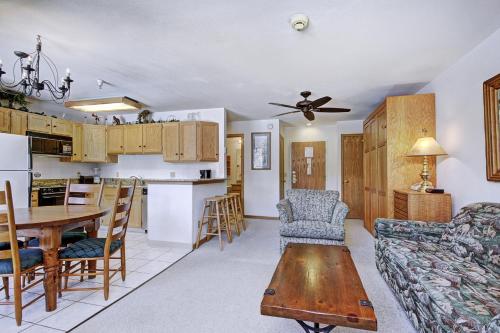 a living room and kitchen with a couch and a table at River Mtn Lodge W110C in Breckenridge