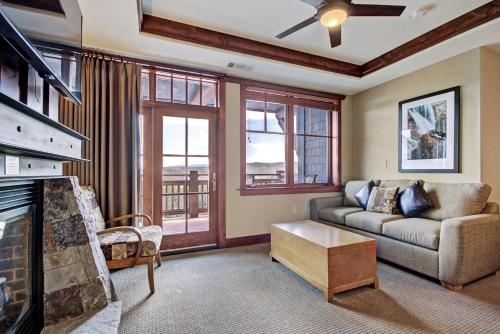 a living room with a couch and a fireplace at One Ski Hill Place S8412 in Breckenridge