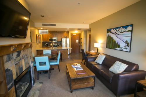 a living room with a couch and a table at Sundial C403 in Park City