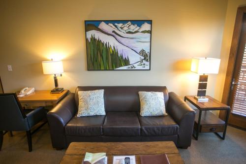 a living room with a couch and a table at Sundial C403 in Park City