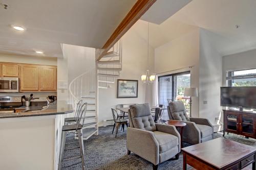 a kitchen and living room with a table and chairs at River Mtn Lodge E301 in Breckenridge