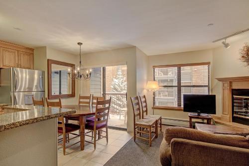 a kitchen and living room with a table and chairs at River Mtn Lodge E215D in Breckenridge