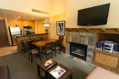 a living room with a table and a fireplace at Sundial - C414 in Park City