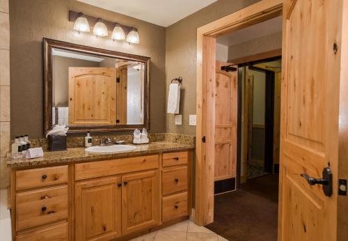 a bathroom with a sink and a mirror at Canyons Village Location Oversized Deck Off in Park City