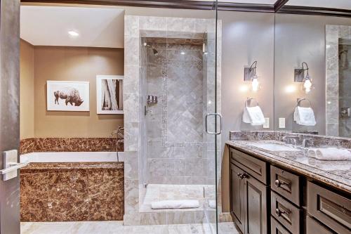 a bathroom with a walk in shower and a sink at Iconic 5 Bedroom Penthouse at the Ritz-Carlton in Vail