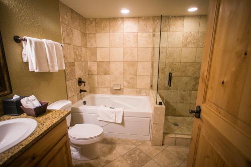 a bathroom with a tub and a toilet and a sink at Silverado 312D in Park City