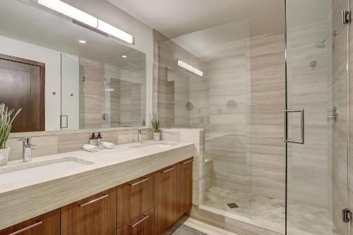 a bathroom with a sink and a glass shower at The Lion Vail- 4 Br Modern Mountain Luxury- 2966 Sq Ft Condo in Vail