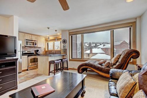 a living room with a couch and a large window at Village at Breck V4510 in Breckenridge