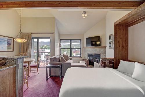 a bedroom with a bed and a living room at River Mtn Lodge E304 in Breckenridge
